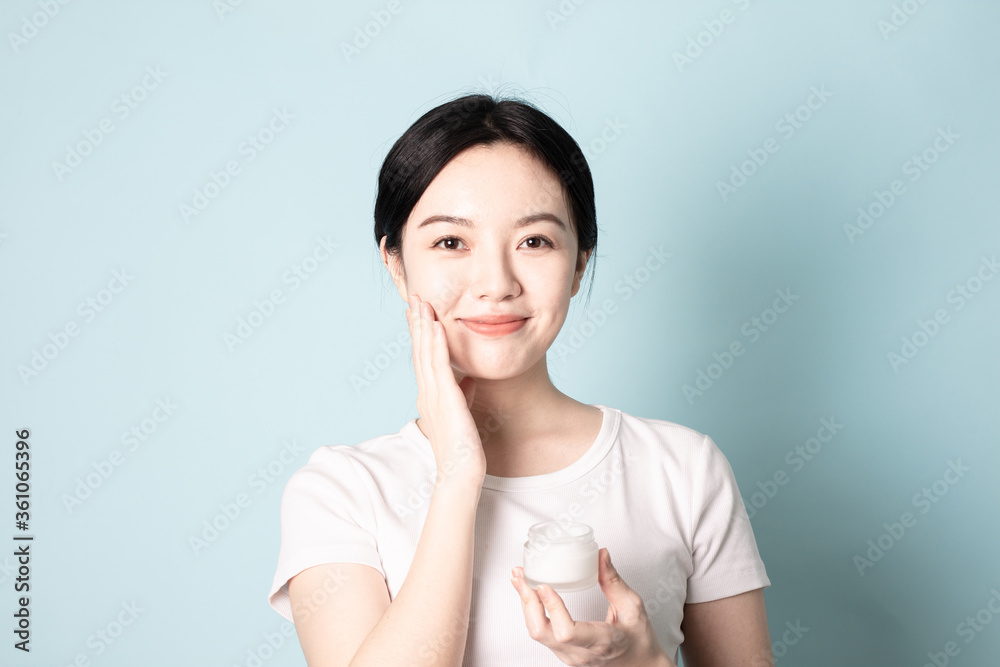 A Young Chinese woman in front of a blue background A Young Chinese woman in front of a blue background