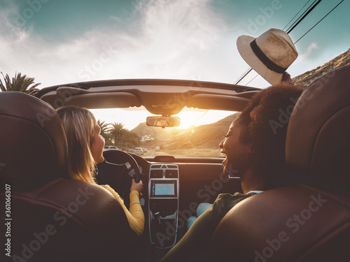 Obraz na plátne Happy girls doing road trip in tropical city - Travel people having fun driving