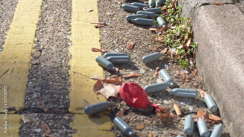 Nitrous Oxide canisters used for drugs on road photo