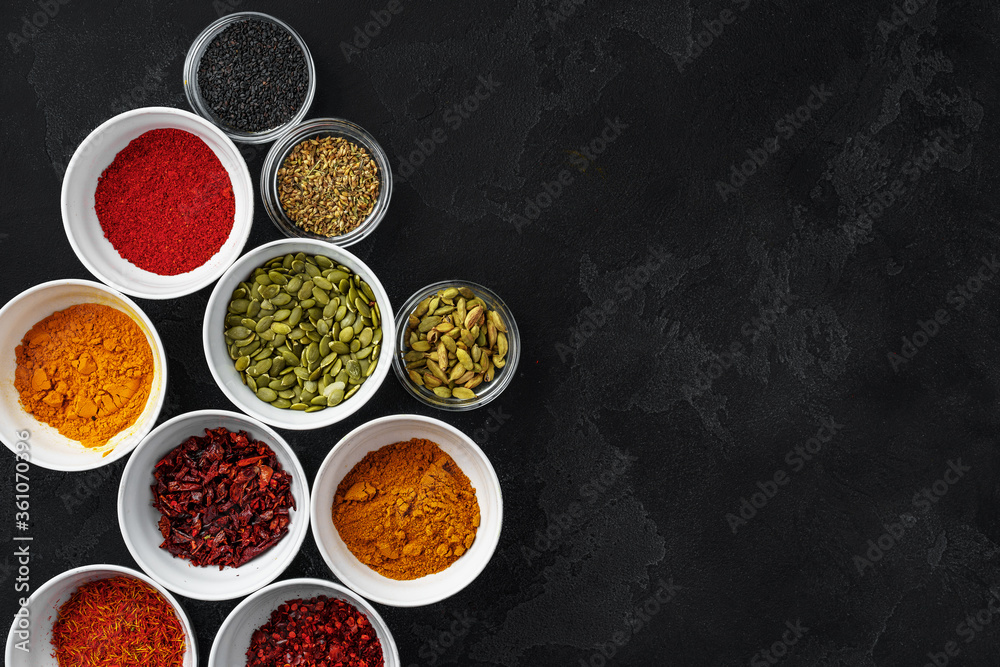 Bowls with assorted spices on dark background Bowls with assorted spices on dark background