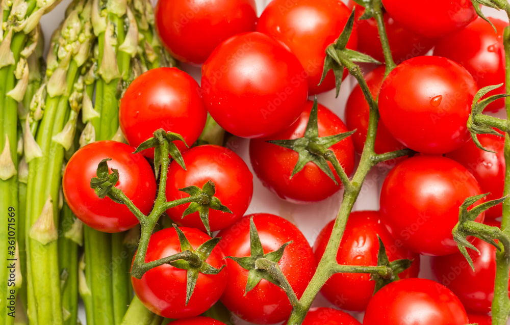 Closup of cherry tomatoes and green asparagus Closup of cherry tomatoes and green asparagus