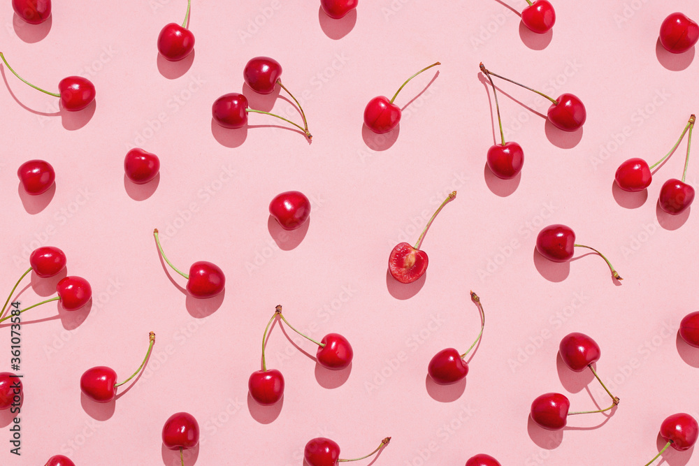 Flat lay of cherries on a pink background. - obrazy, fototapety, plakaty 