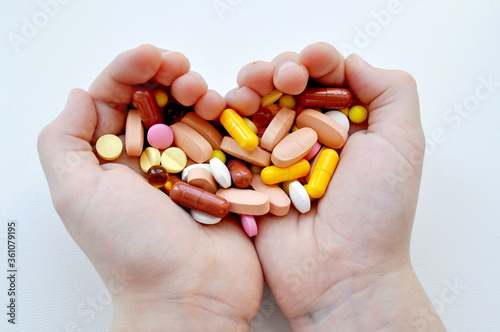  Photo with pills, multi-colored pills in hands.Medicines.