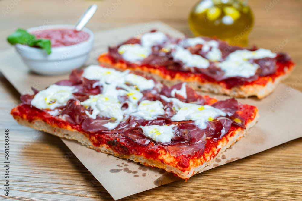 Pizza with tomato, prosciutto, sour cream and olive oil Pizza with tomato, prosciutto, sour cream and olive oil