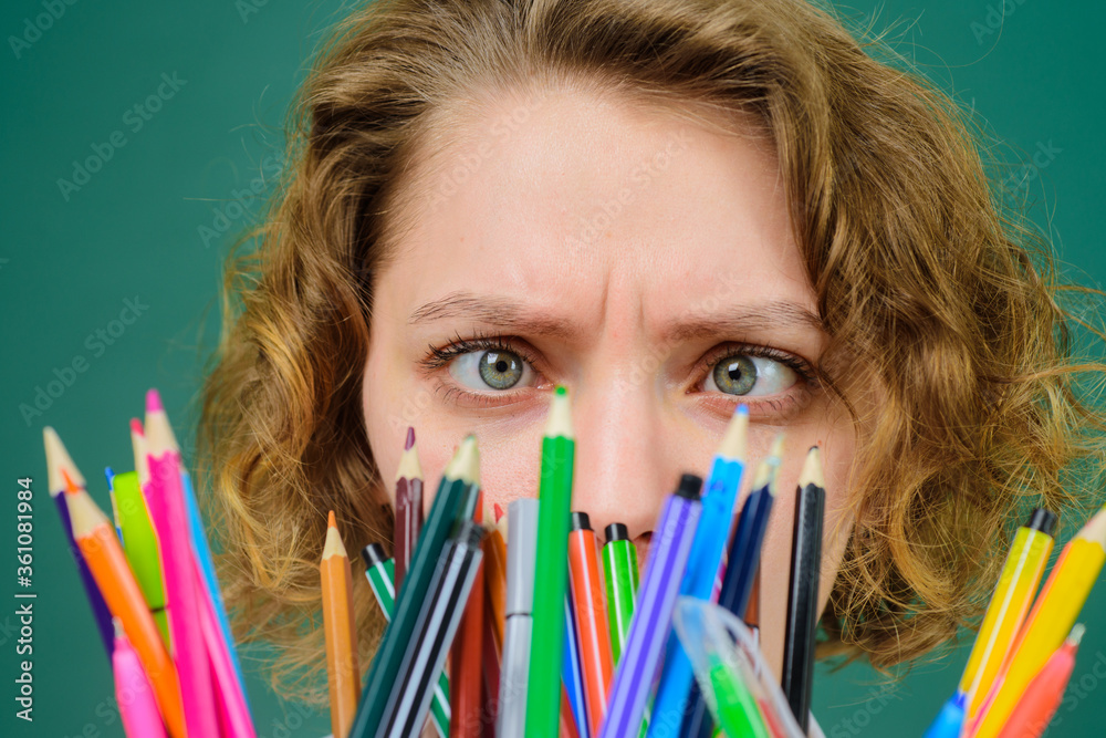September 1. Back to school. Funny teacher. School supplies. Pen. Pencils. Education. School. Job. Teacher in classroom. Close up portrait of teacher. September 1. Back to school. Funny teacher. School supplies. Pen. Pencils. Education. School. Job. Teacher in classroom. Close up portrait of teacher.