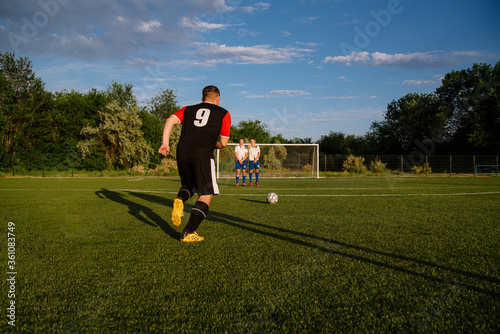 Soccer player kicks the ball.Soccer player takes the free-kick.