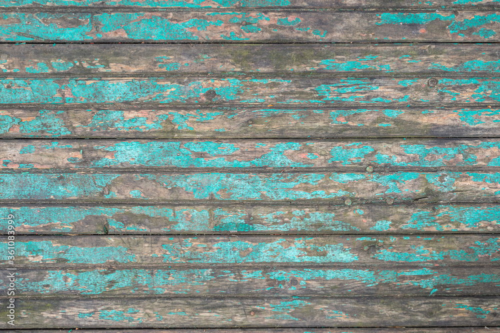 Texture of an old wooden table with peeling blue paint