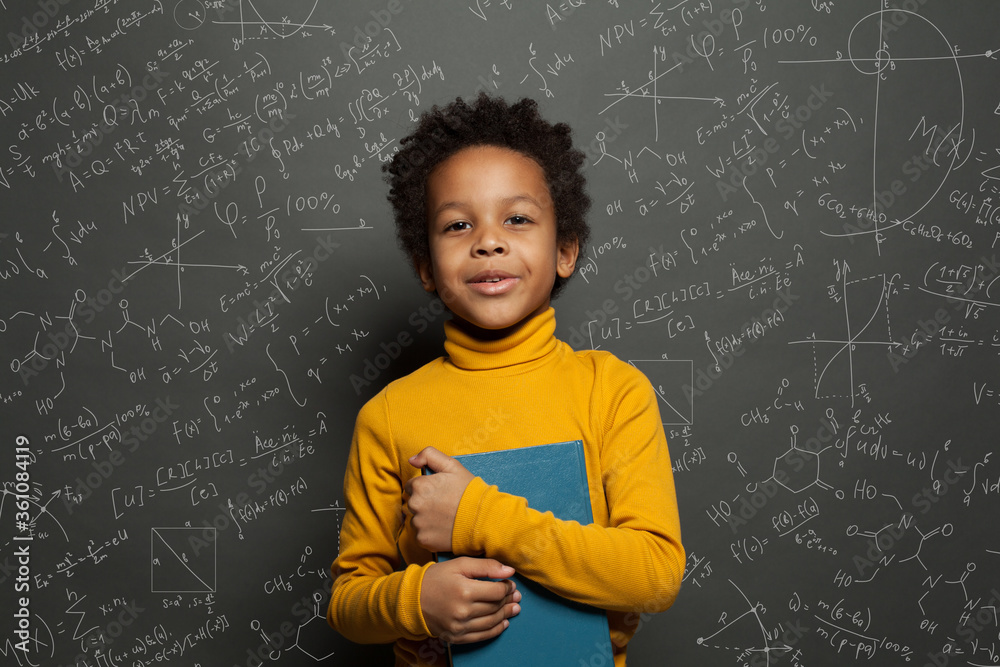 African American child student on blackboard background with science and maths formulas