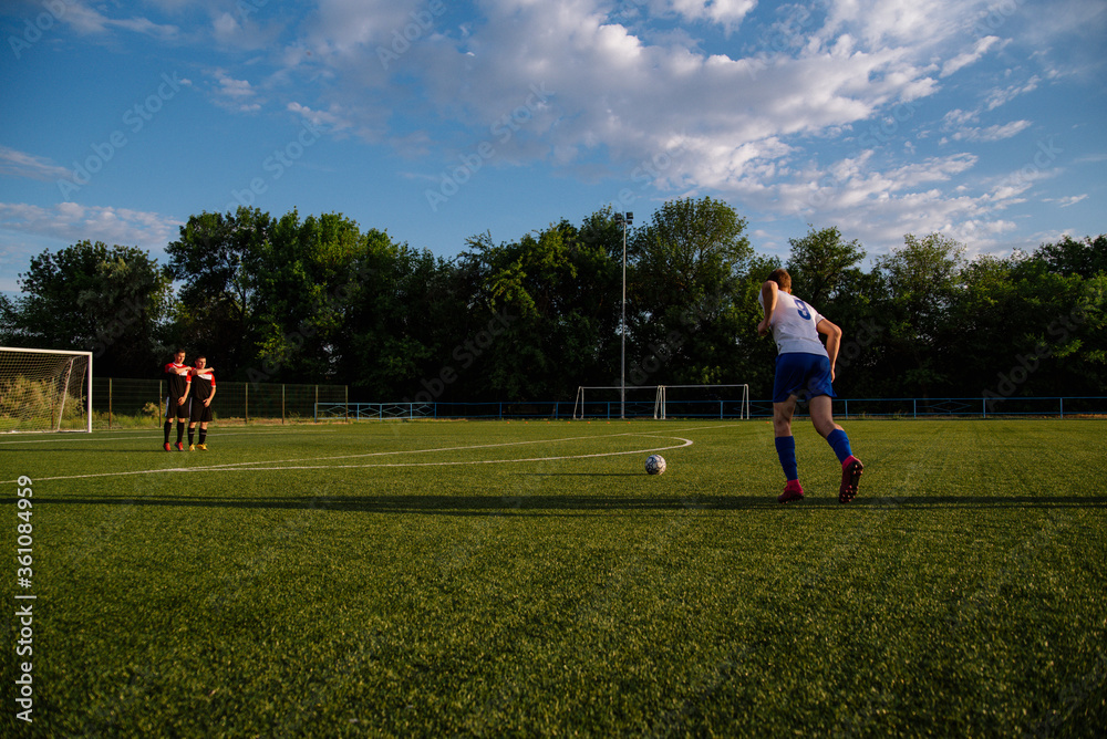Soccer player kicks the ball.Soccer player takes the free-kick. Soccer player kicks the ball.Soccer player takes the free-kick.
