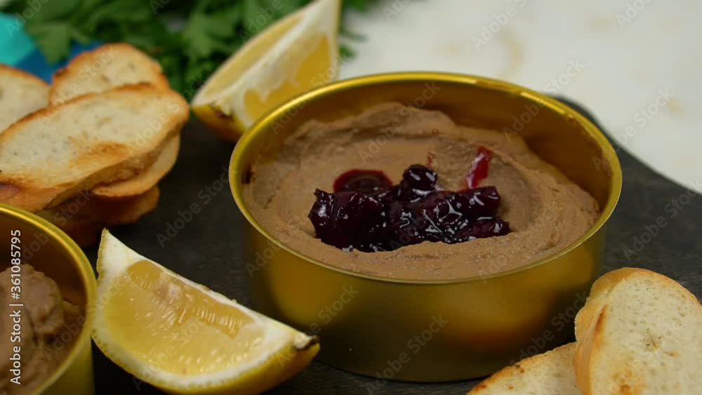 Chicken liver pate with cherry jam. The chef pours cherry sauce on the