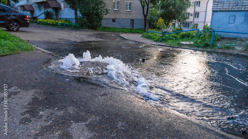 Water flows out of road sewage hatch