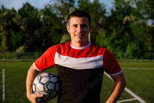 Soccer player with a ball in his hands