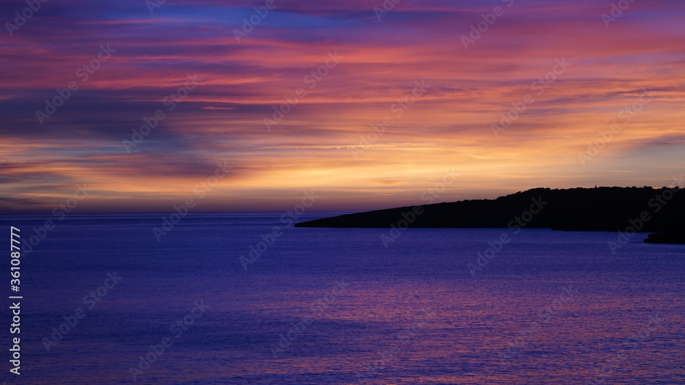 the sunset in Cala Ratjada on the island Mallorca, Spain, in the month of January