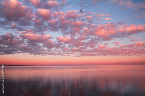 Clouds reflected on the water during sunset