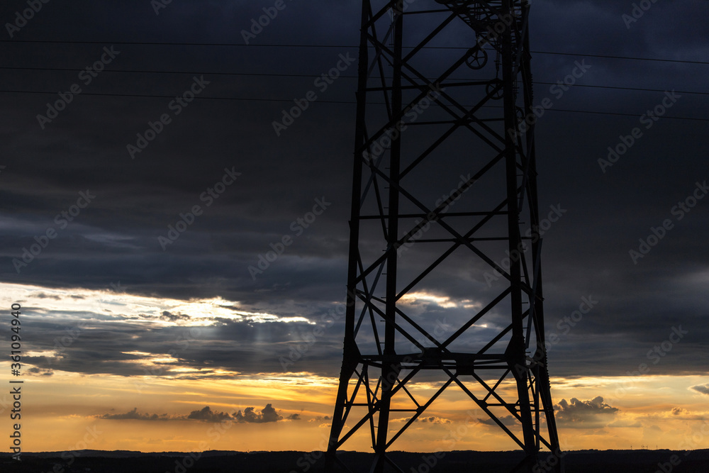 an Electricity pylon in front of an evening sky