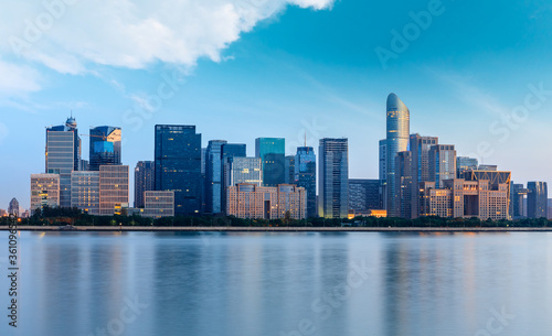 Hangzhou city skyline and architectural reflections at sunrise,China.