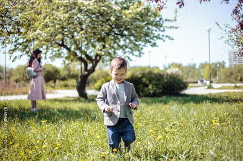 Little boy walks in a spring park