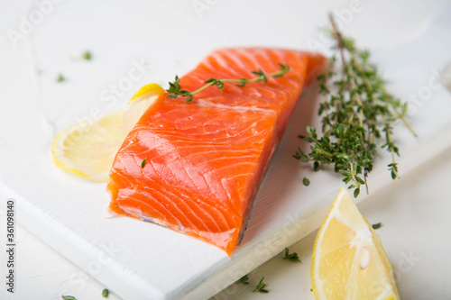 A piece of smoked salmon with thyme and lemon
