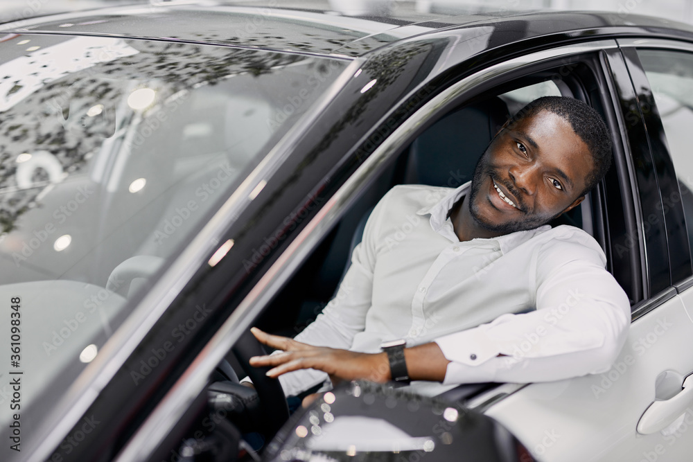 business man sits inside of expensive luxurious car in dealership, he makes purchase, dreams come true business man sits inside of expensive luxurious car in dealership, he makes purchase, dreams come true