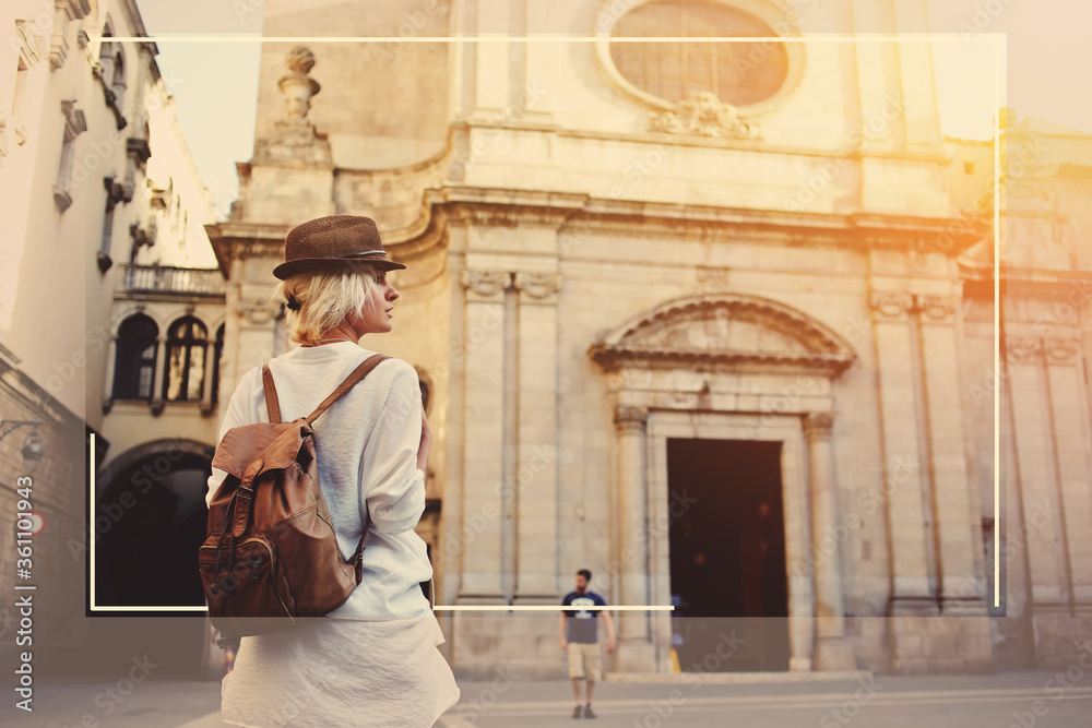 Back view of young female wanderer out sightseeing in  foreign city during weekend overseas, woman tourist with rucksack walking near unfamiliar historic architecture building during travel