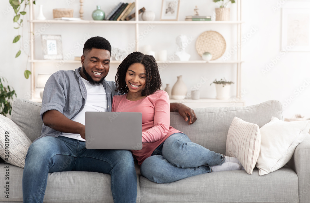 Weekend Passtime. Married Afro Couple Using Laptop At Home Together, Watching Movies Weekend Passtime. Married Afro Couple Using Laptop At Home Together, Watching Movies