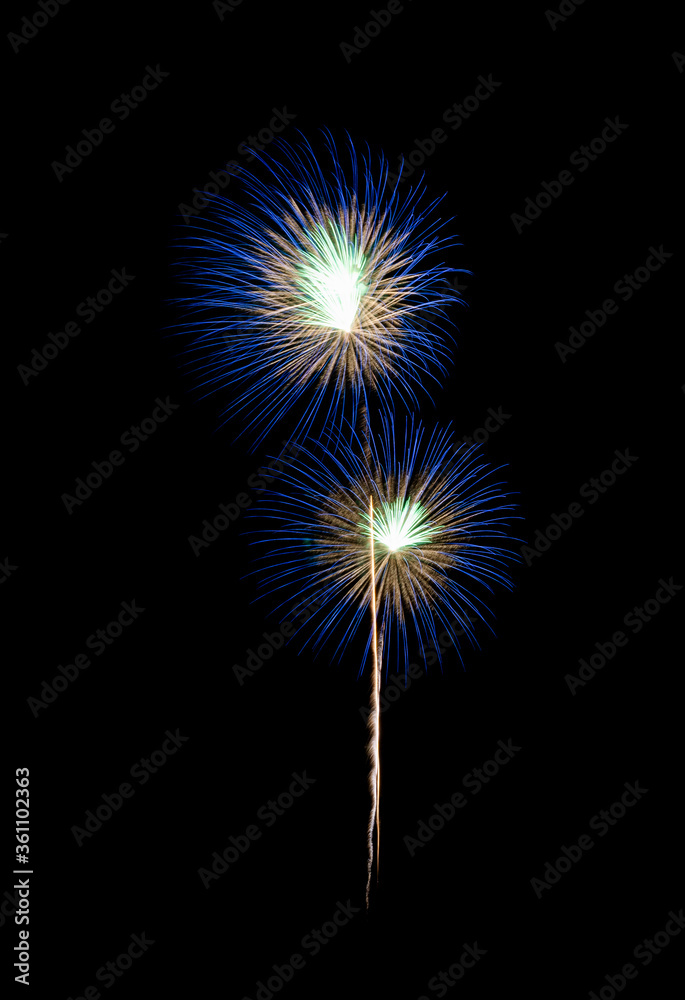 Blue fireworks exploding on night sky.