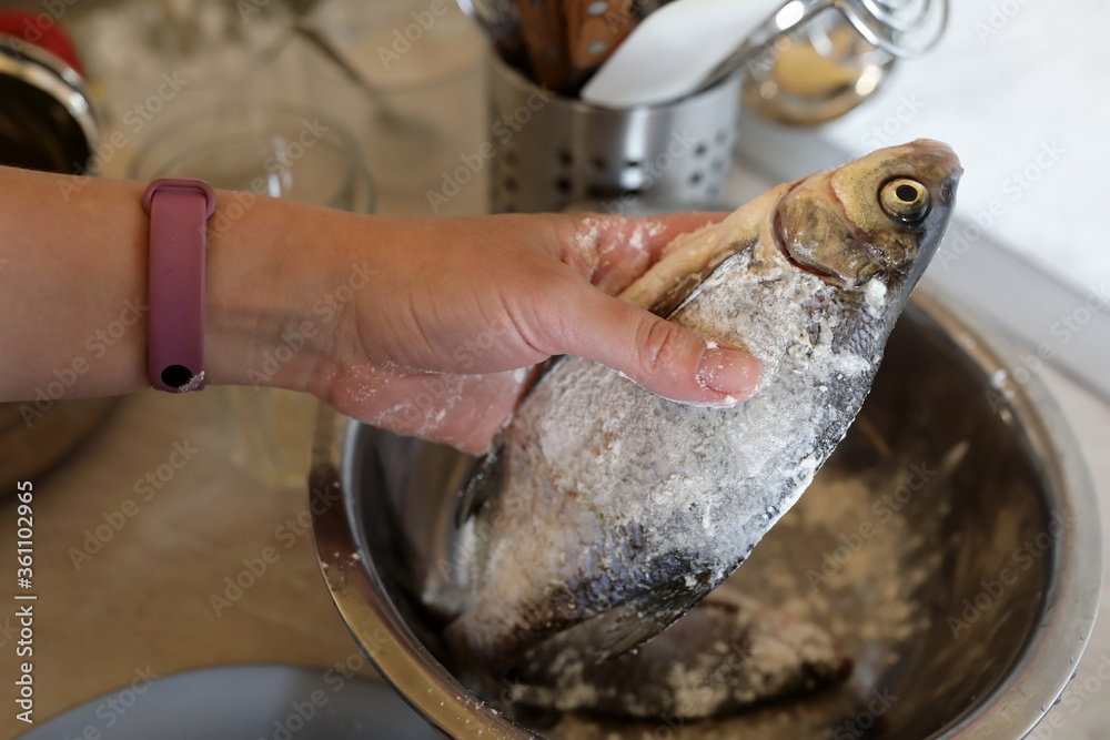 Chef dips fish in flour