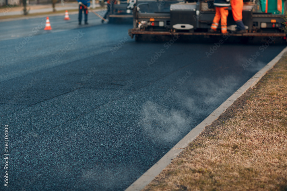 Asphalt paving. Paver machine and road roller. New road construction