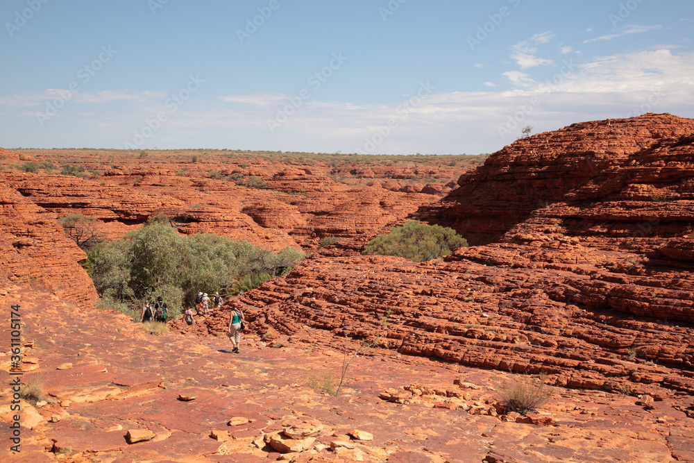 Fototapeta premium Tourists hiking in Kings Canyon outback central Australia