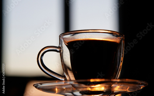 cup of coffee on the table at sunset