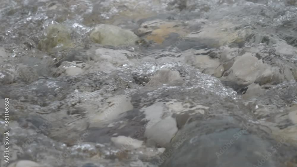 Clear water streaming over stones in a shallow river. Clear water streaming over stones in a shallow river.