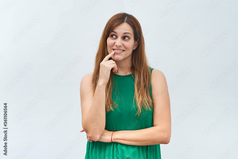 Young woman making the gesture of thinking isolated on a white background. Young woman making the gesture of thinking isolated on a white background.