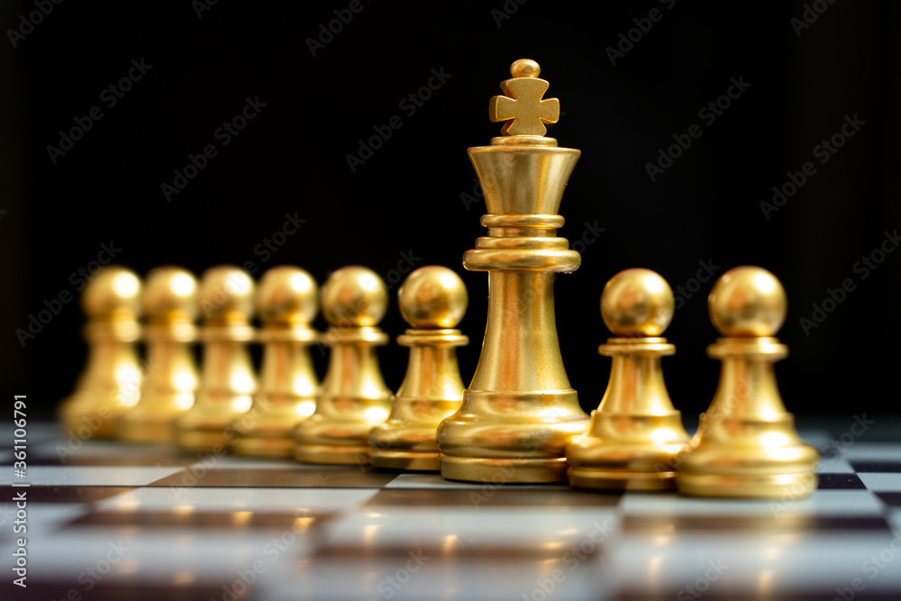 Gold king chess piece stand with pawn on black background (Concept of teamwork, management) Gold king chess piece stand with pawn on black background (Concept of teamwork, management)