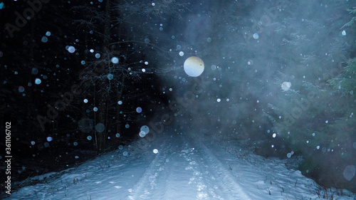 Bokeh of Christmas snowfall on forest road