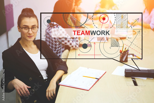 Half length portrait of positive attractive female employee in eyeglasses looking at camera while colleagues on background working having meeting in office, teamwork concept with infographics element