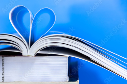 Stack of paper books on blue background