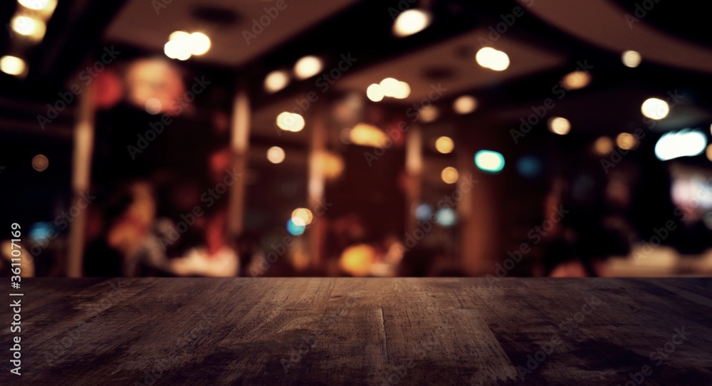 Empty dark wooden table in front of abstract blurred bokeh background of restaurant . can be used for display or montage your products.Mock up for space. Empty dark wooden table in front of abstract blurred bokeh background of restaurant . can be used for display or montage your products.Mock up for space.