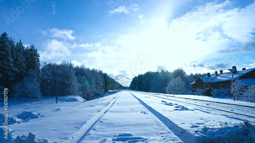 Railway in snow. Winter landscape with empty rail tracks
