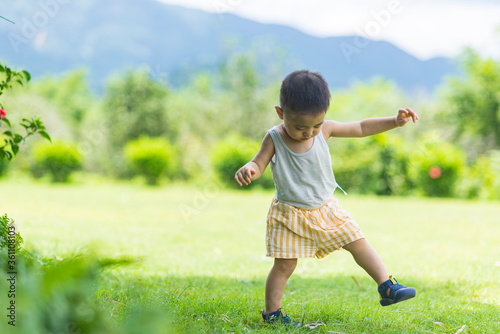 A little boy playing on the grass 