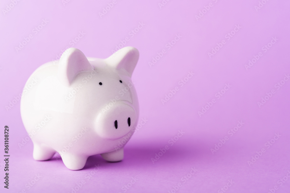 Front small white fat piggy bank, studio shot isolated on purple background and copy space for use, Finance, deposit saving money concept