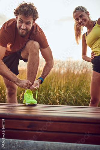 Young adult sporty couple working out outdoors.