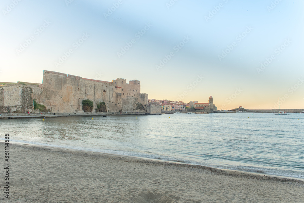 Old town of Collioure, France, a popular resort town on Mediterranean sea, panoramic view with the Royal castle in sunrise light
