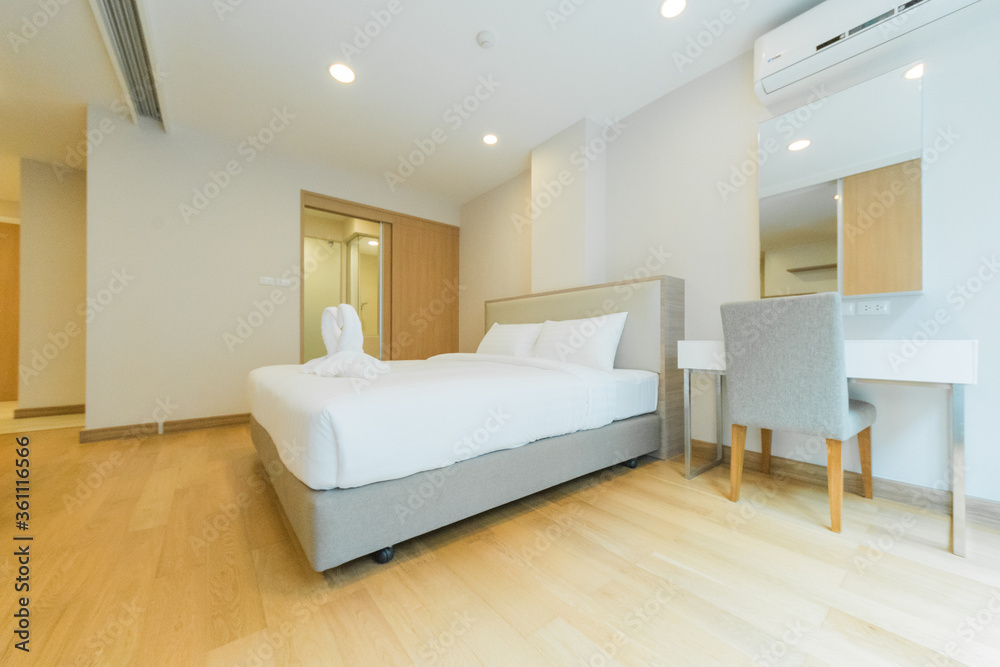 White pillows on wooden bed in minimal bedroom interior