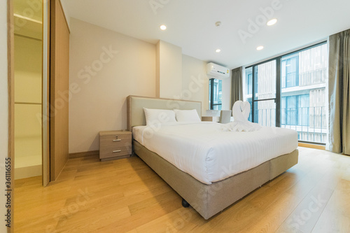 White pillows on wooden bed in minimal bedroom interior