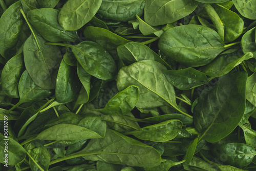 Fresh green spinach leaves. Healthy food, vegetarian diet concept. Top view, texture