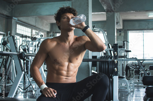 Man drinking water after doing exercise