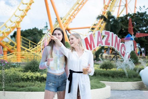 Wallpaper Mural Two Girls are enjoying and happy at an amusement theme parks. Torontodigital.ca