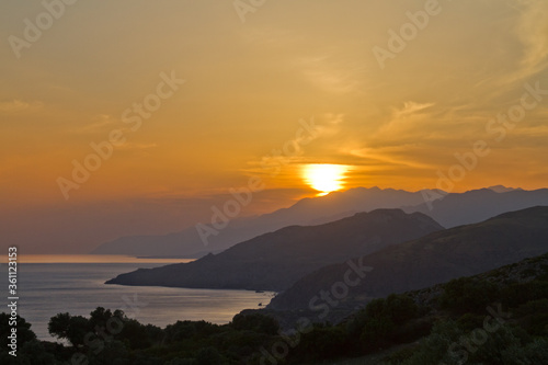 Silhouettes of hills on the coast of Crete at sunset