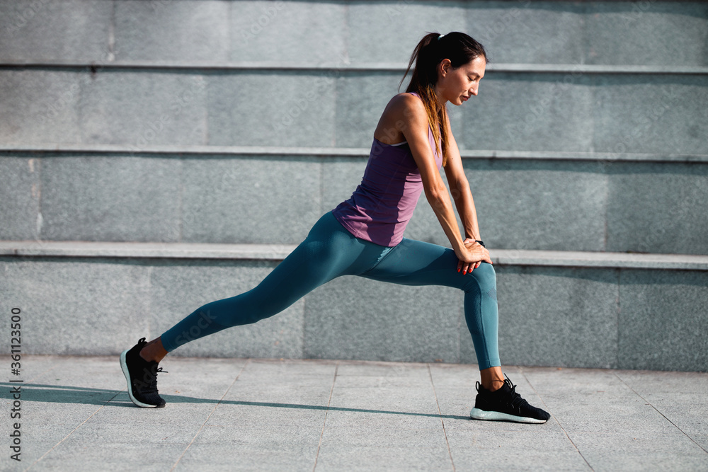 Young woman doing a stretching exercise Young woman doing a stretching exercise