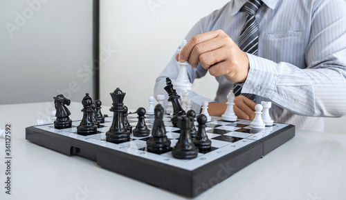 Bild auf Leinwand Businessman playing chess and thinking strategy about crash overthrow the opposi